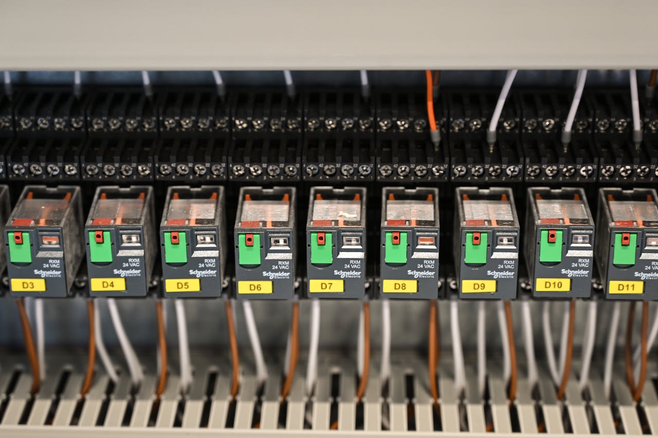 digital Close-up view of electrical relays in an industrial panel box showcasing circuit components.